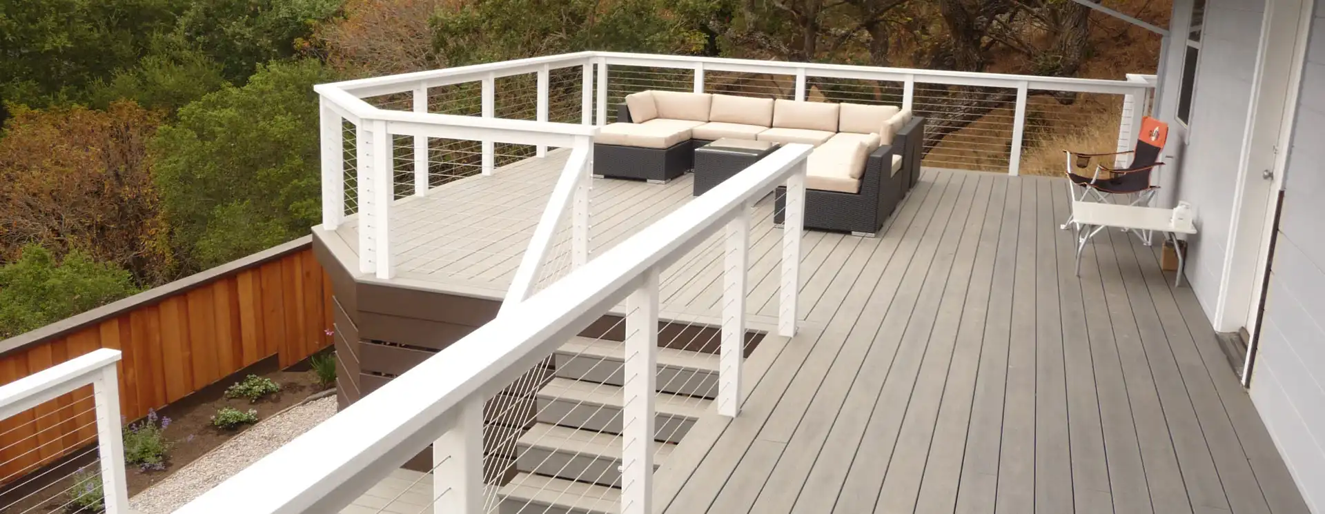 photo of a composite deck with cable railing and deck steps - Composite Deck Builders in Belmont CA