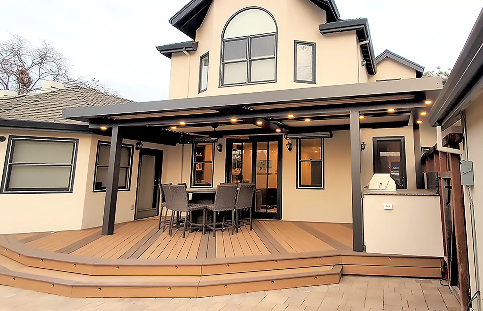 photo of a composite deck with pergola and outdoor furniture