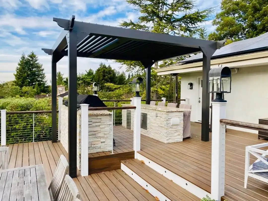 photo of a multi-level deck with pergola providing cover for an outdoor kitchen and bar