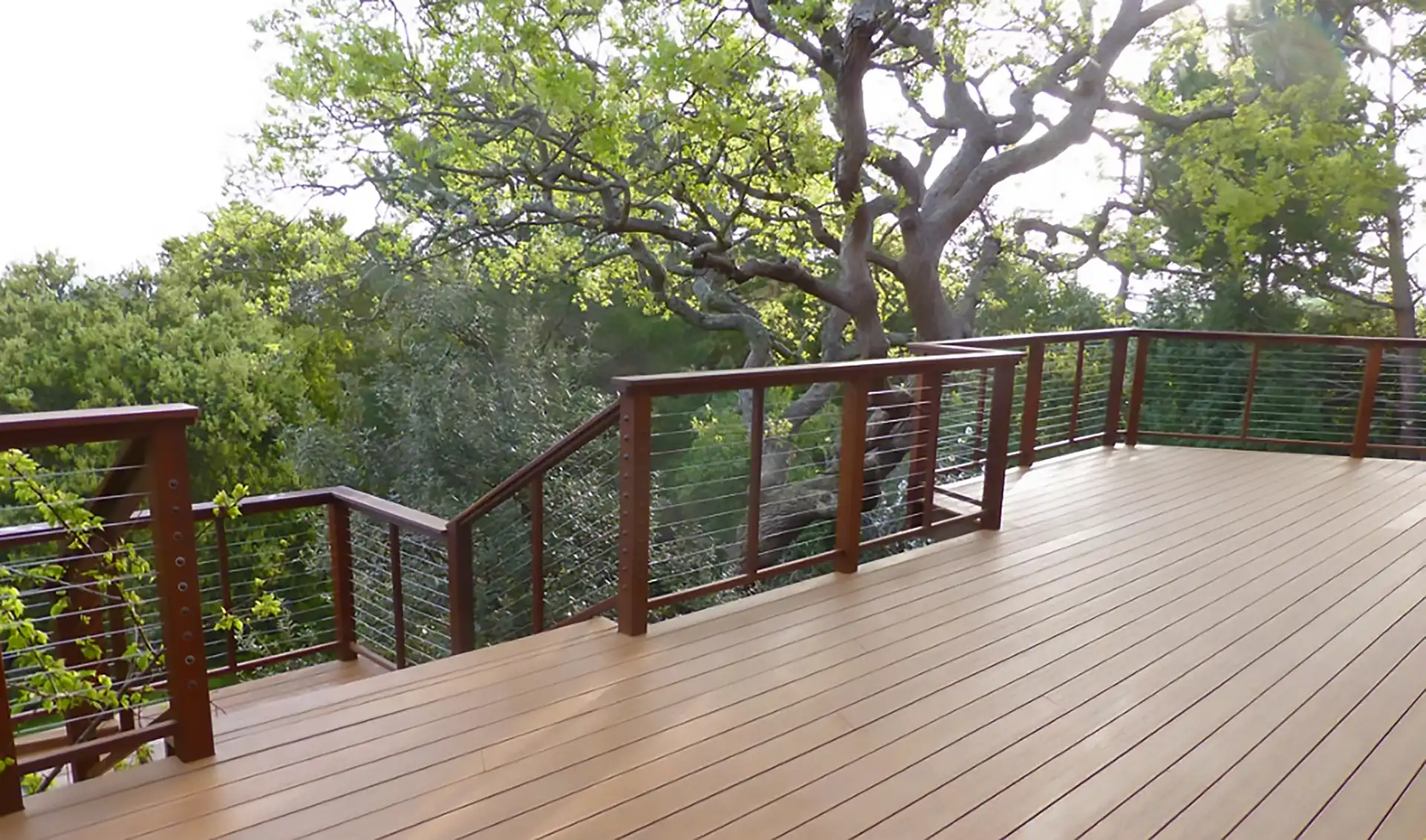 photo of a multi-level deck with a scenic view of a wooded area from the upper level - Multi Level Decks builder near me in San Francisco Bay Area