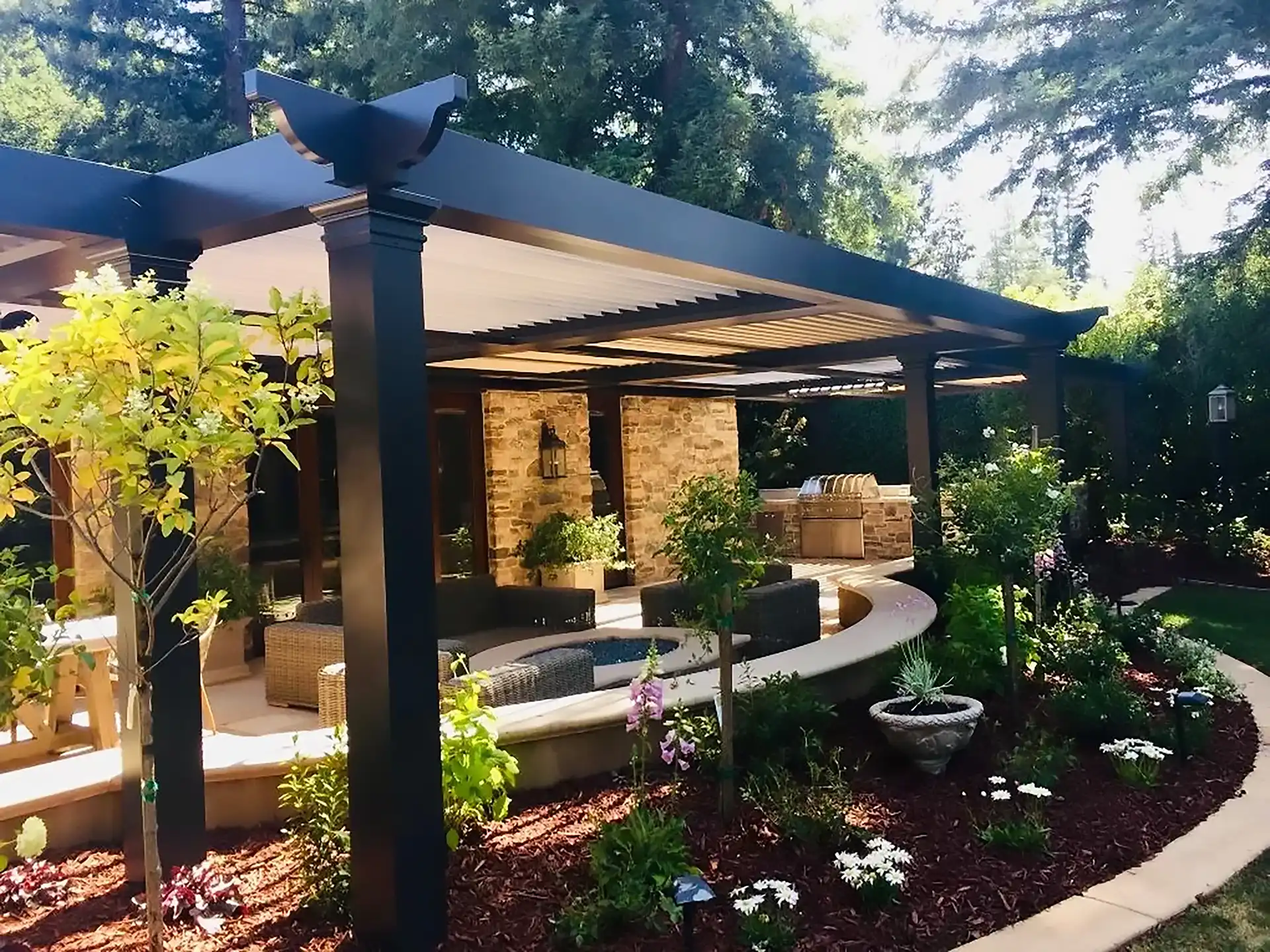 ALT Text photo of a StruXure pergola and patio with outdoor kitchen and plants