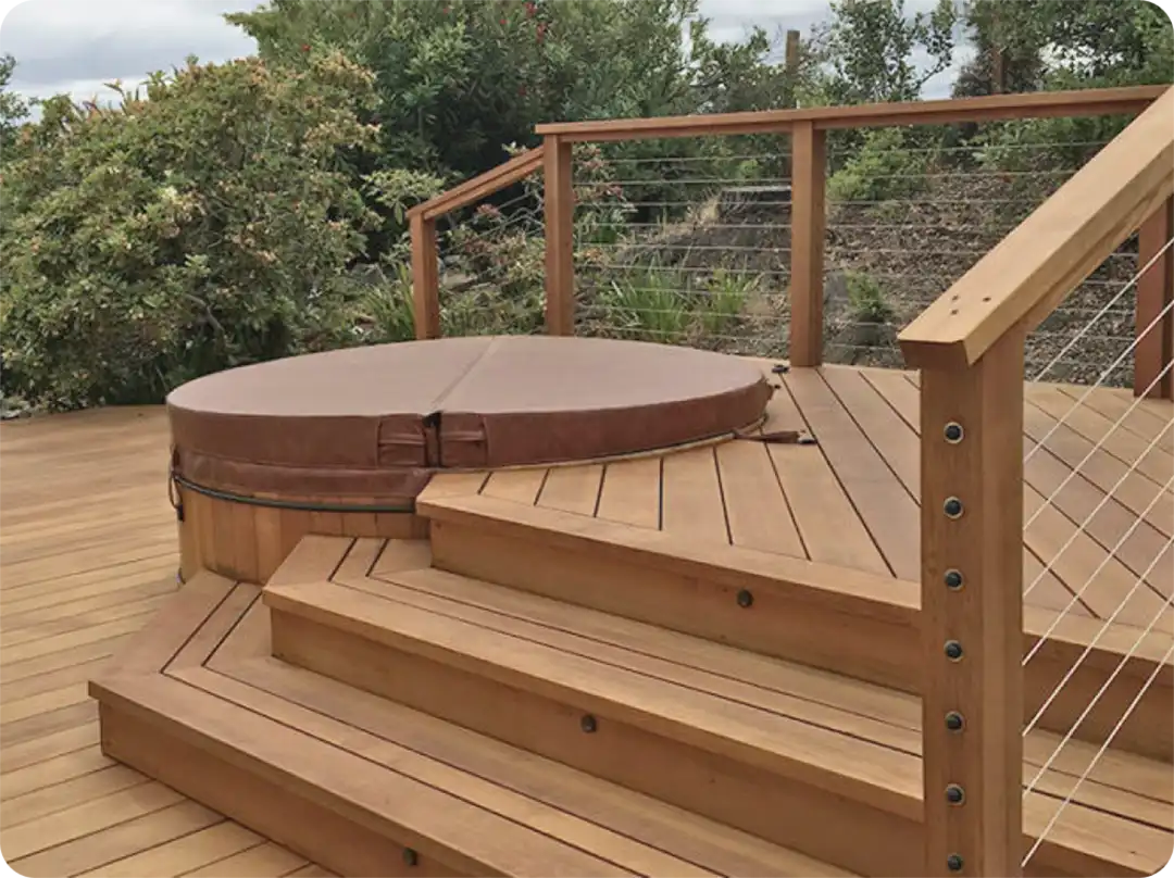 Photo of a wood deck with hot tub and cable railing - Wood Deck Building Company in the San Francisco Bay Area