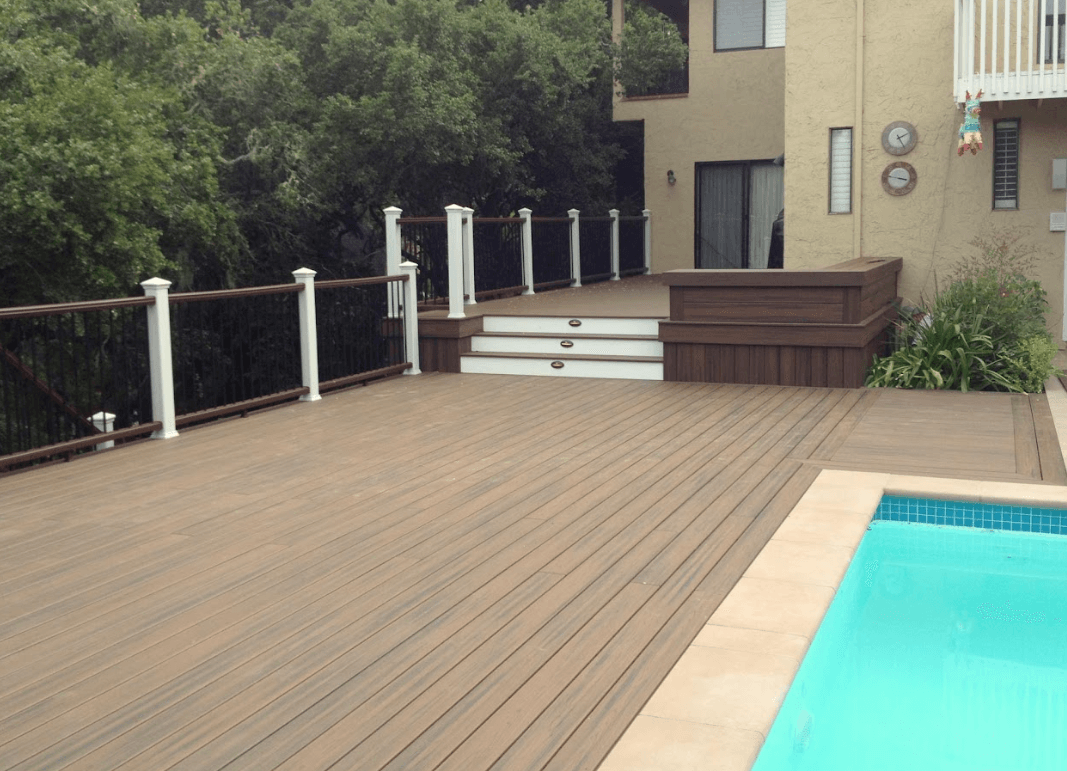 Photo of a custom deck with multiple levels and one level of the deck serving as a pool deck