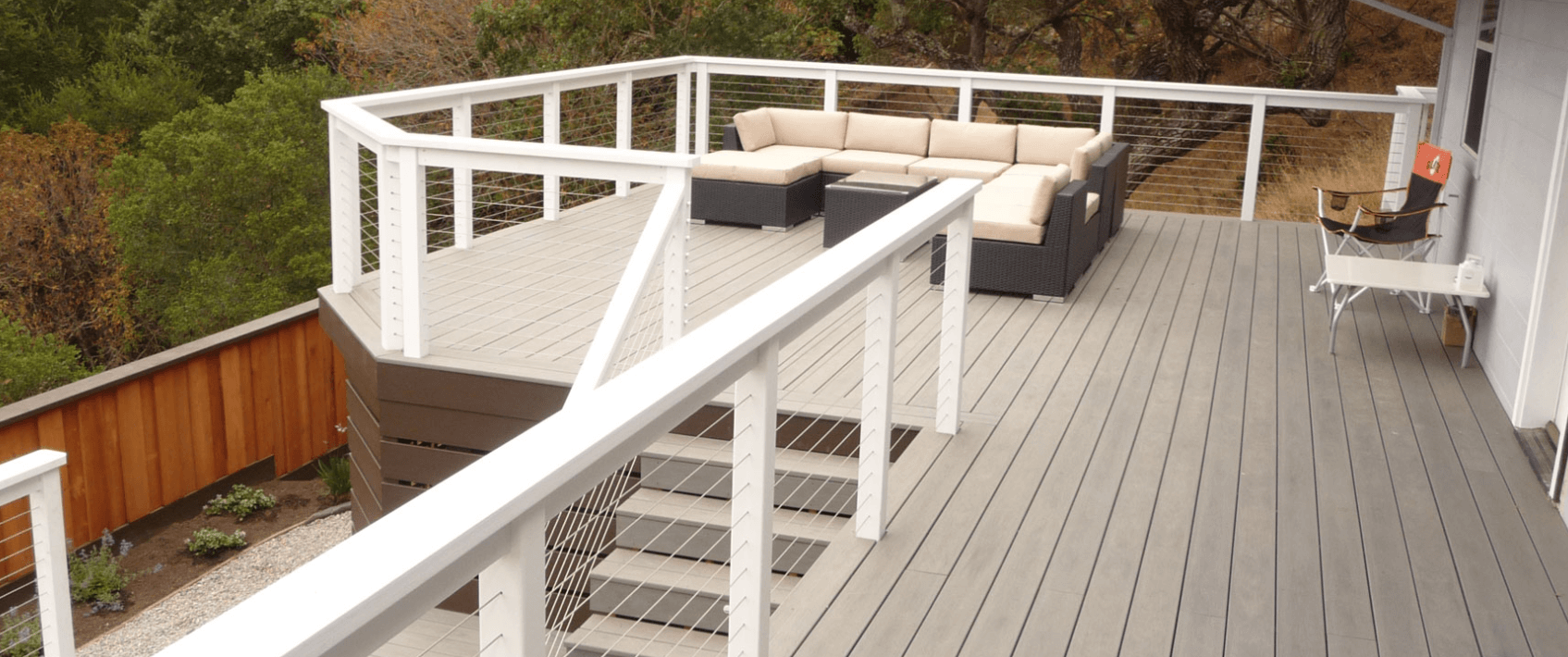 photo of a composite deck with cable railing and deck steps