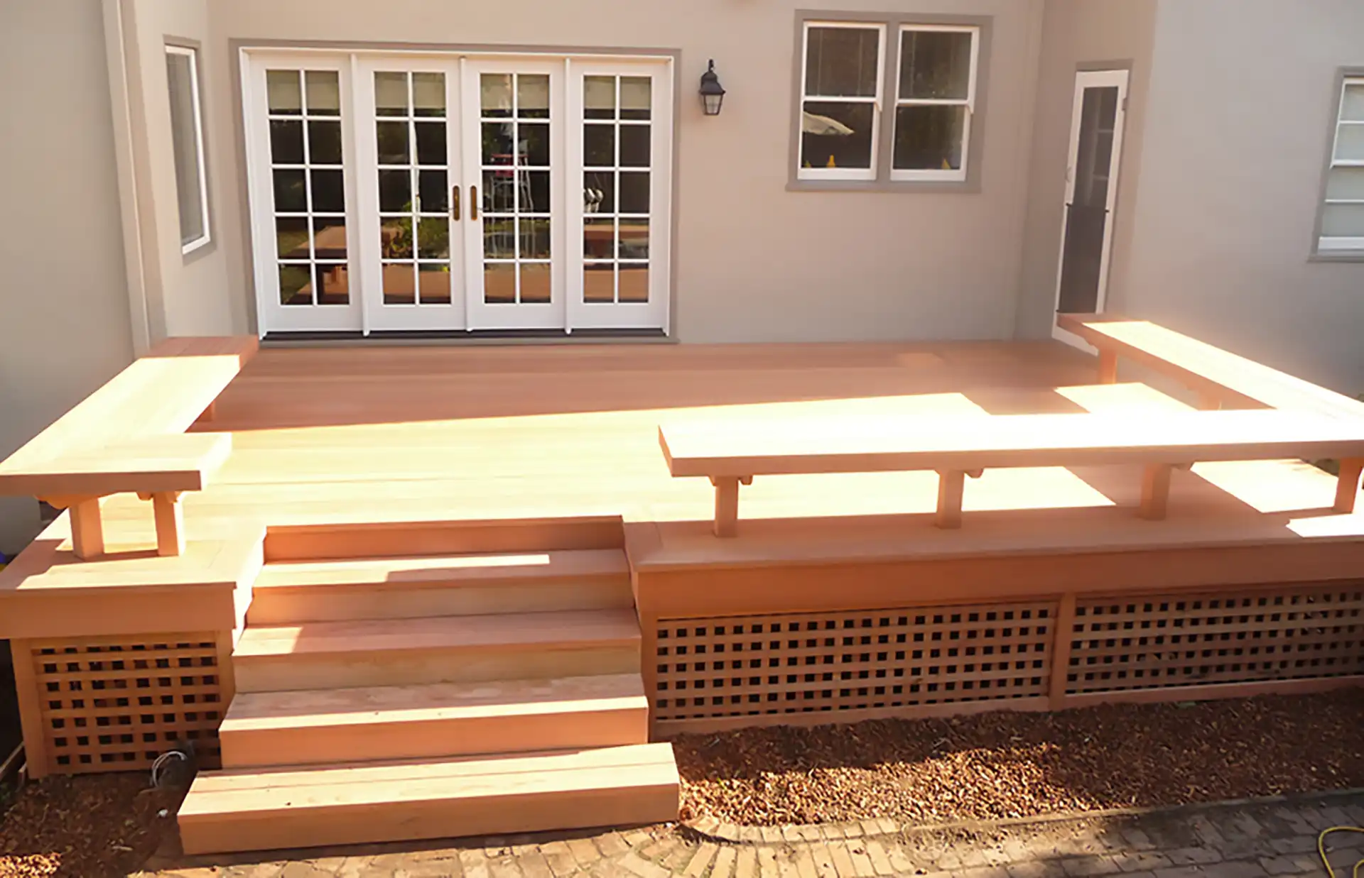raised deck attached to a house. Because it is attached to a house, you will need a permit to build this deck in California.